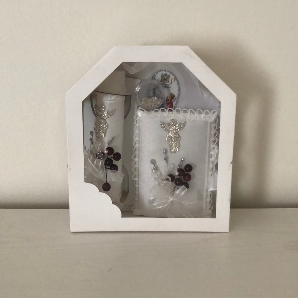 1st communion candle, bible, and rosary.